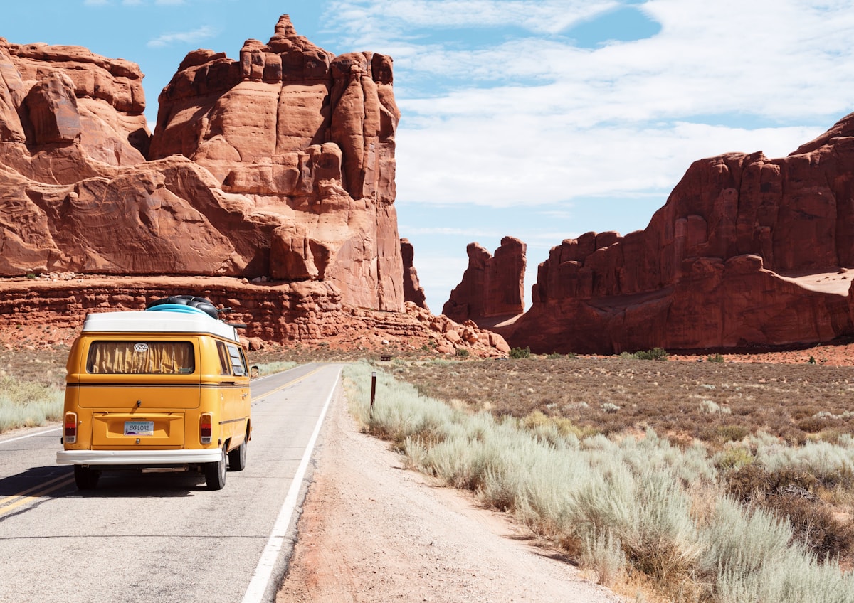 An open road through a dramatic landscape