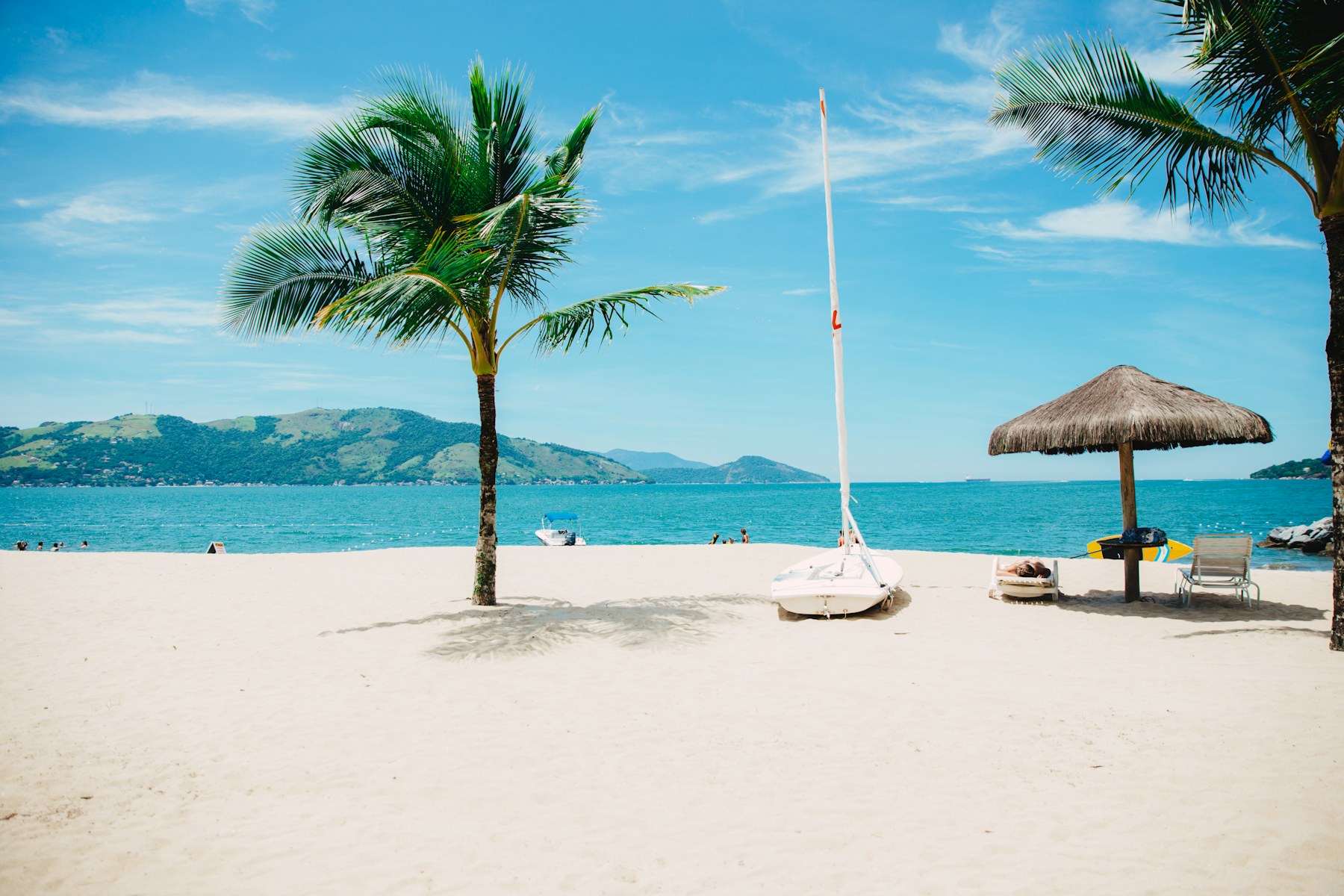 A quiet tropical bay seen through palm trees